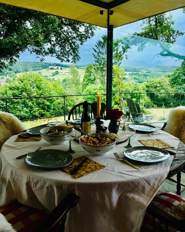 a table with plates of food and bottles of wine at Slow Refuge in Fanzel