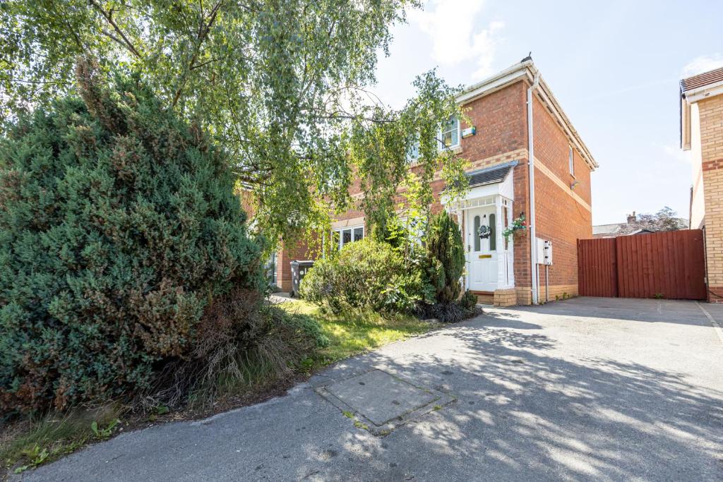 an empty street in front of a brick building at Manchester Serenity House in Manchester