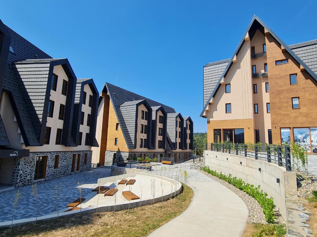 a row of buildings with a pool in the middle at Alpino in Divčibare