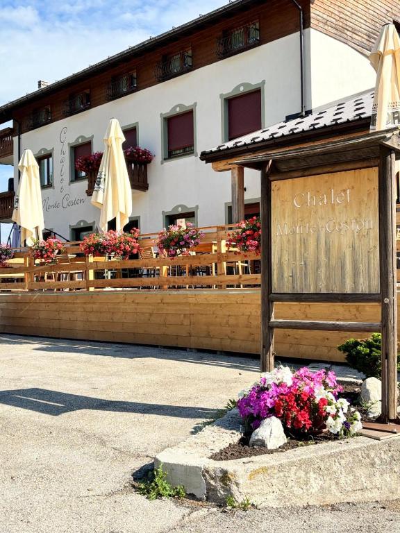 a restaurant with a sign in front of a building at Chalet Monte Coston in Lastebasse