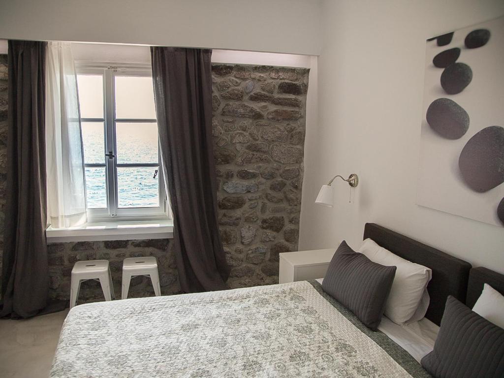 A bed or beds in a room at Olive Press Hotel & Apartments