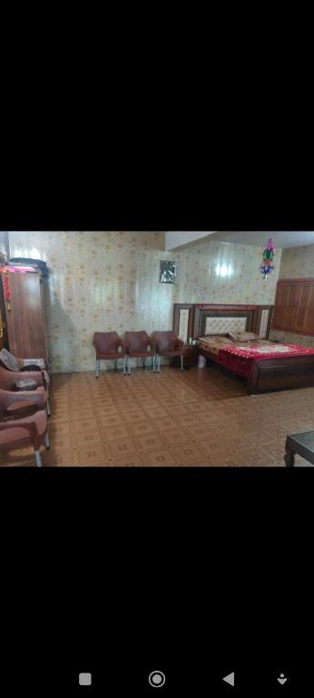 a living room with a couch and chairs in a room at WanderNest BirmiGali in Abbottābād
