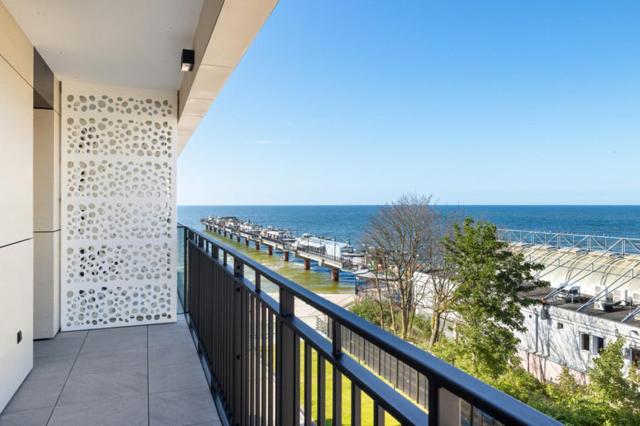 a balcony with a view of the beach at Baltic View Resort&SPA Apartment 316 - Side Sea View in Międzyzdroje