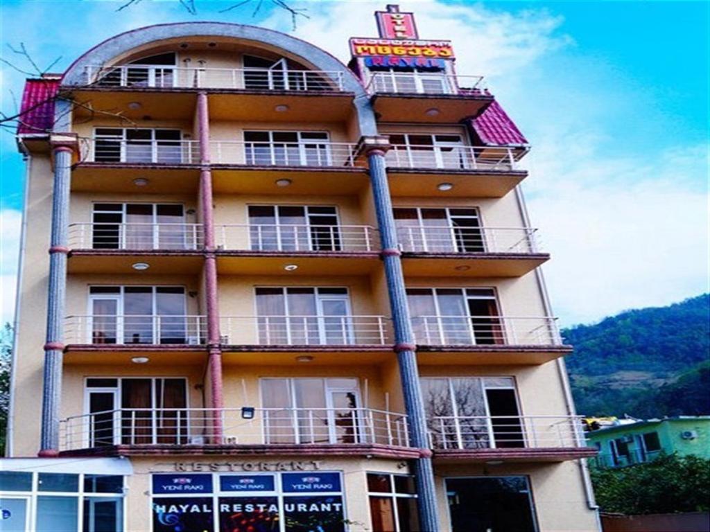 a tall building with a sign on top of it at Hotel Otsneba in Kvariati