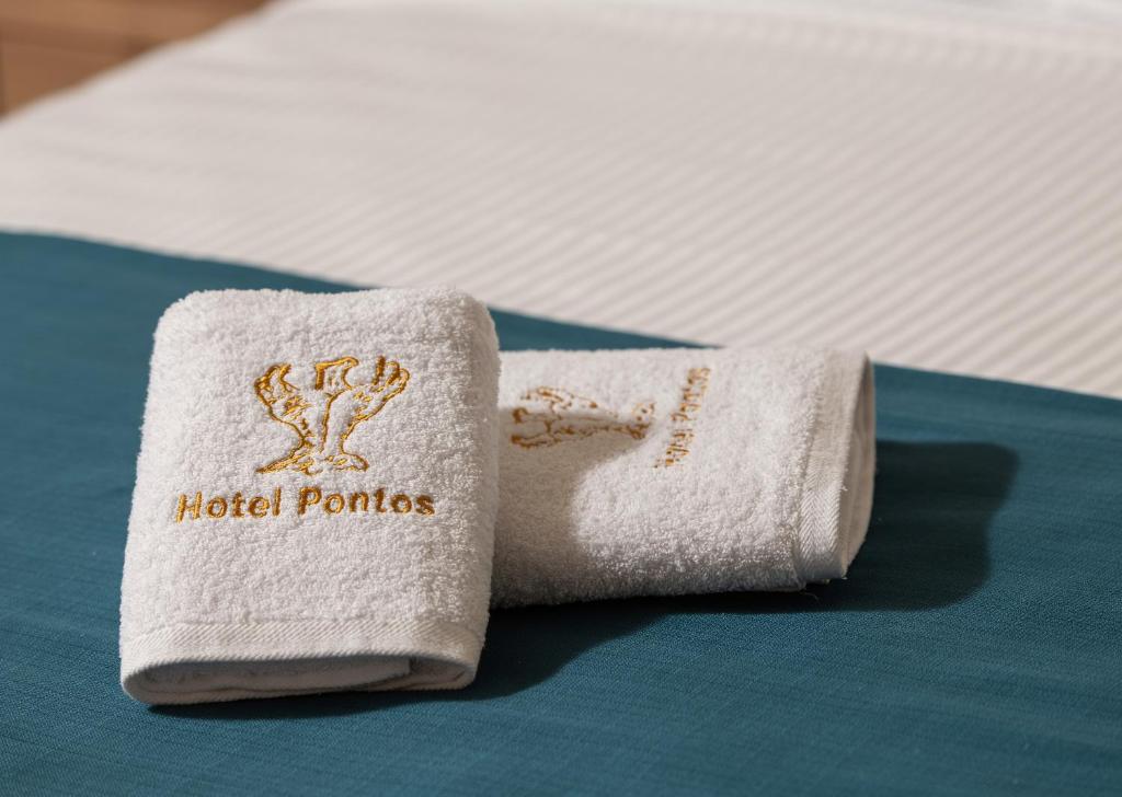 Postel nebo postele na pokoji v ubytování Hotel Pontos