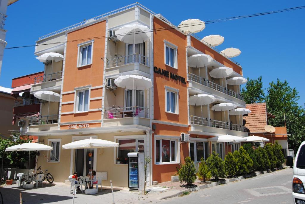 a large building with umbrellas in front of it at Avsa Cane Motel in Avşa Adası