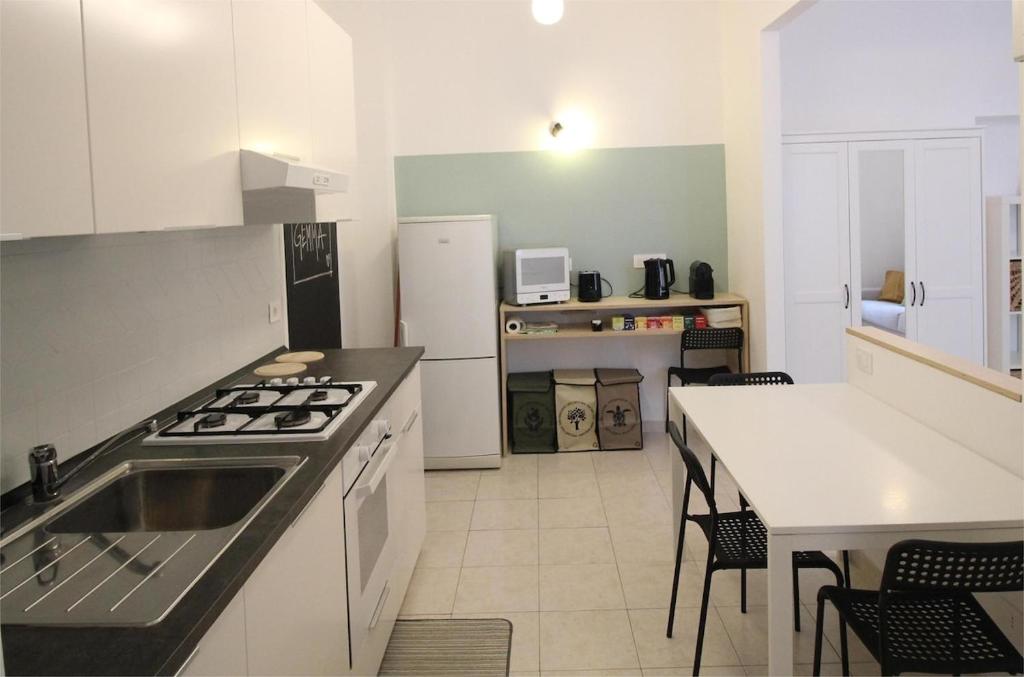 a kitchen with a sink and a stove top oven at Appartamento La Gemma in Parma