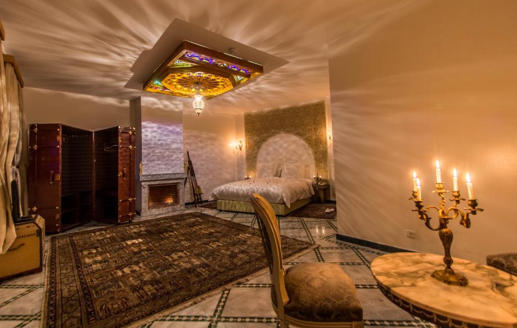 a living room with a bed and a fireplace at Riad Amor - Suite & Spa in Fès