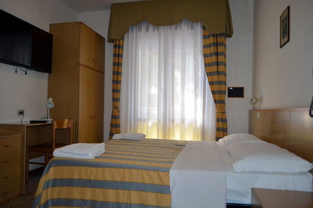 Postel nebo postele na pokoji v ubytování Hotel Altinate