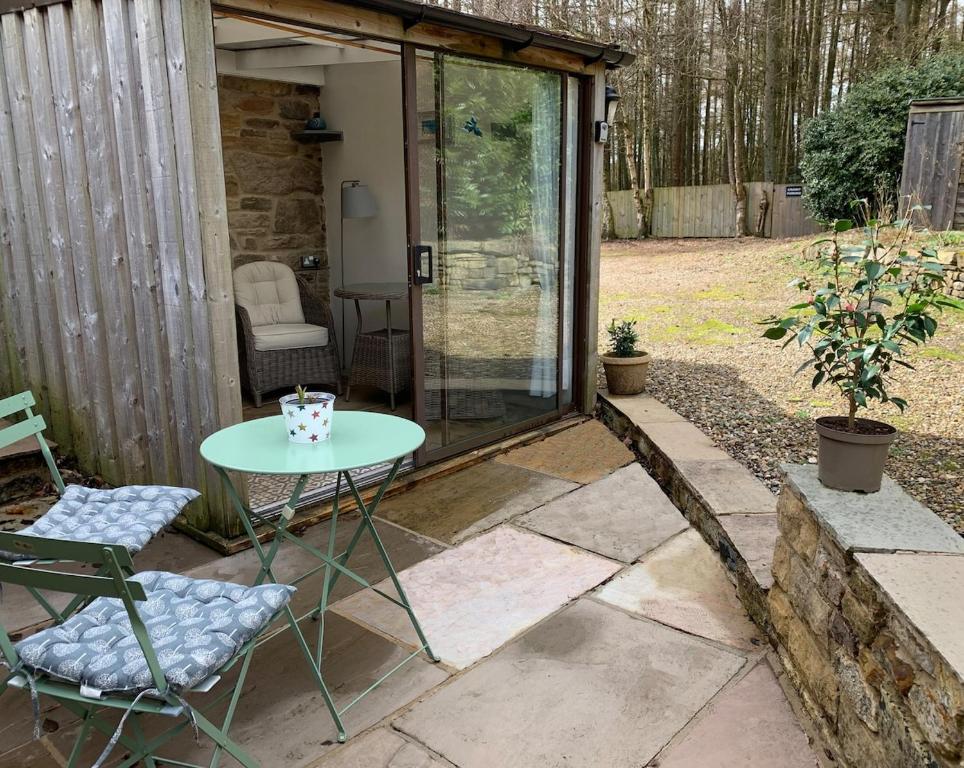 a small patio with a table and chairs at The Cranny in Broxa