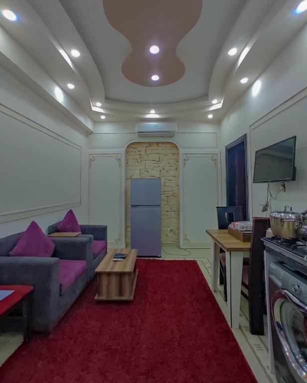 a living room with a couch and a table at SARAYA AWAD HEGAZI STREET- families only in Alexandria