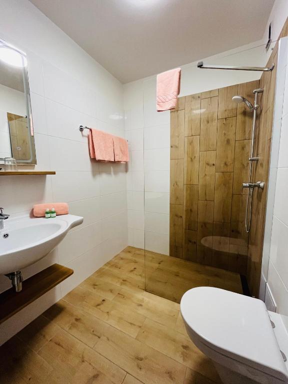 a bathroom with a shower and a toilet and a sink at Apartment Gastein 3 in Bad Gastein