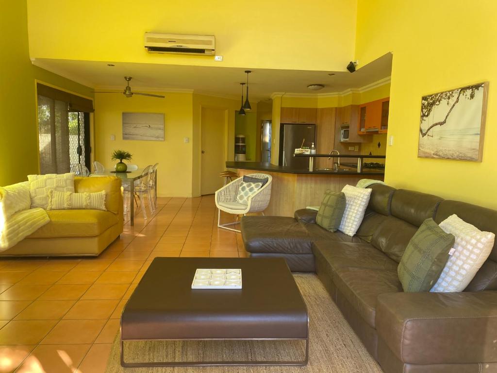 a living room with a couch and a table at Amazing Perfect Family Home - GC Beach location in Gold Coast