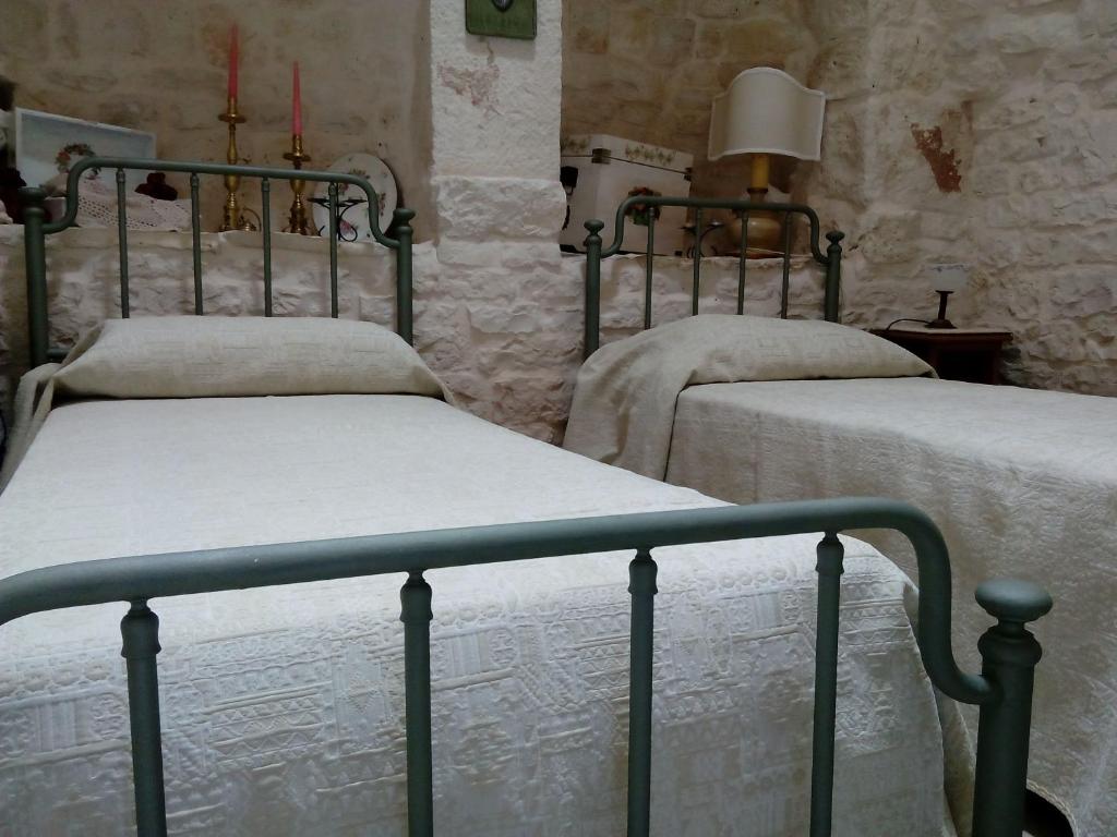 A bed or beds in a room at Trulli Sarmenzanello