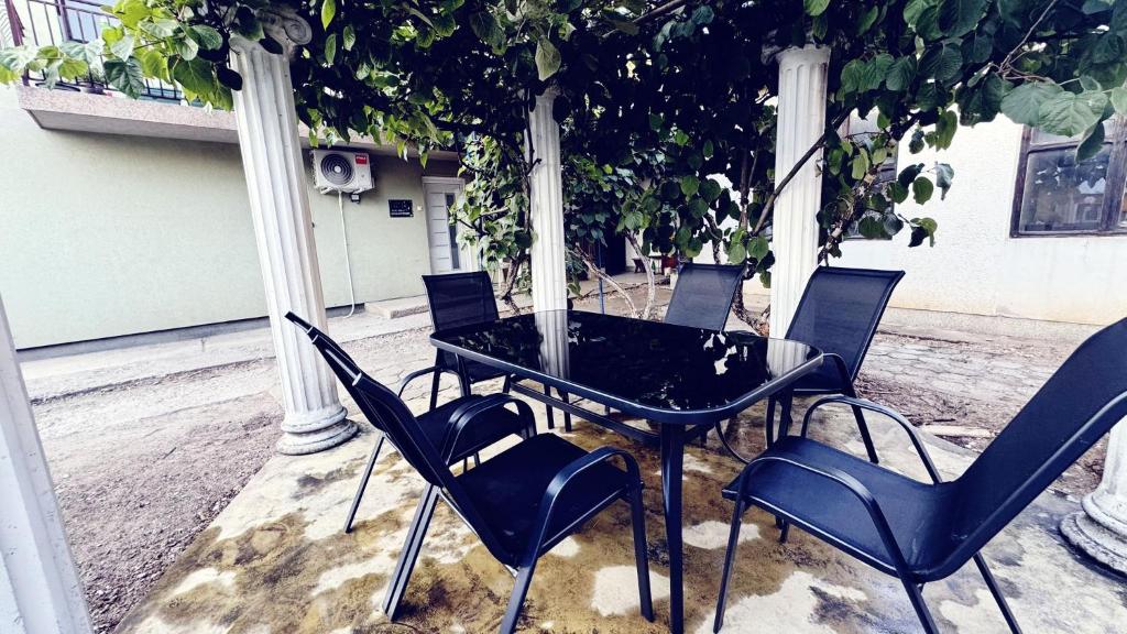 a black table and chairs on a patio at Lucky Apartments in Leskovac