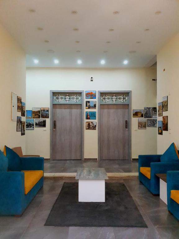 a lobby with two wooden doors and a table at زافيرو محطه الرمل للعائلات فقط - families only in Alexandria