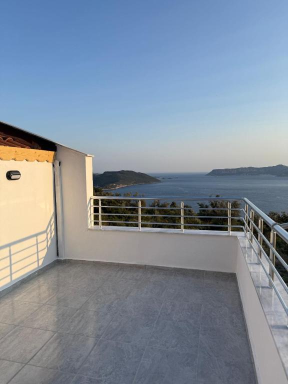 a balcony with a view of the ocean at Gökkuşağı Pansiyon in Kaş