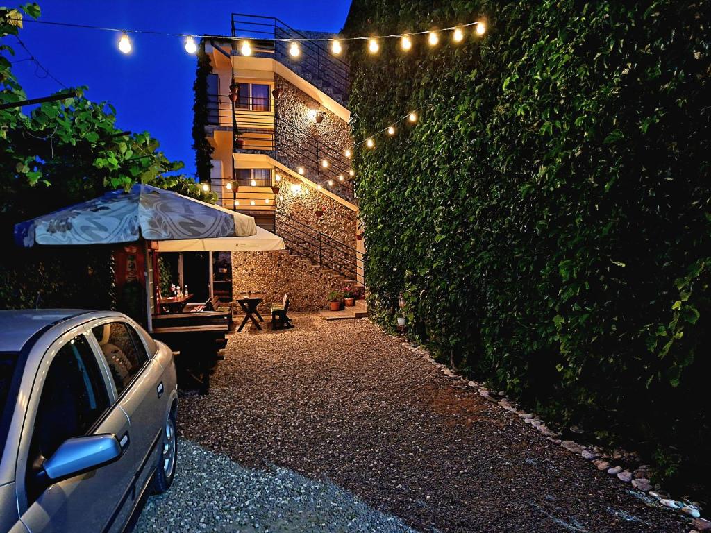 a car parked in front of a building with lights at Casa Nicolas in Costinesti