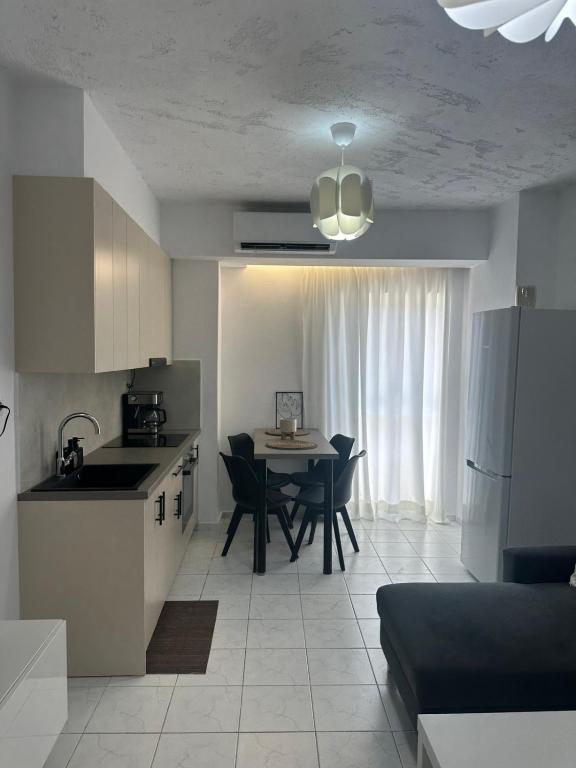 a kitchen and dining room with a table and a refrigerator at Joseph Seaside Apartment 5 in Heraklio