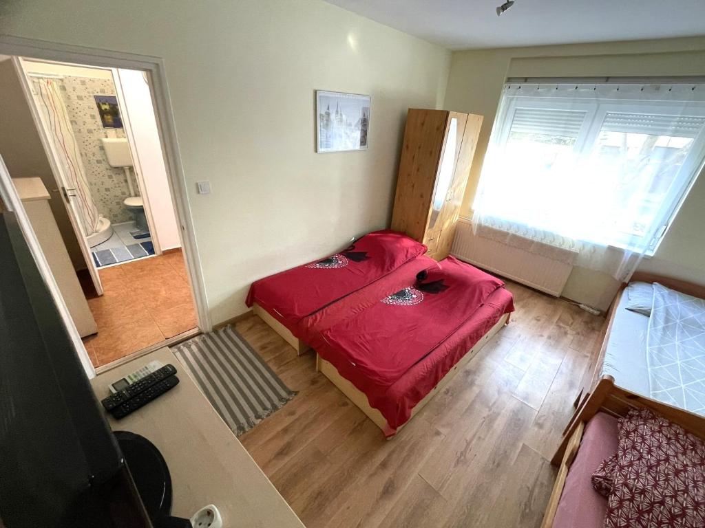 a room with a red bed in the corner of a room at Red Locomotive Apartment in Budapest