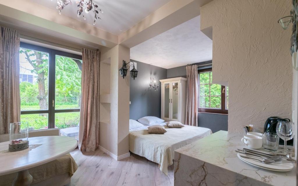 a bedroom with a bed and a large window at Willa Ahava in Kazimierz Dolny