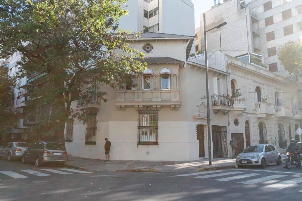 a building on a street with cars parked in front of it at Fliphaus Mansion Paz B - 10 pax Deluxe House Belgrano in Buenos Aires