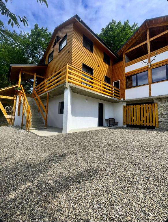 a house with a staircase in front of it at Cabana NEST in Bistricioara