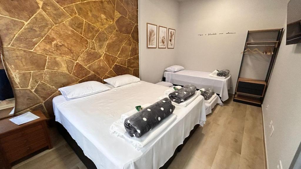 a room with two beds in a room at Aconchego BH in Belo Horizonte