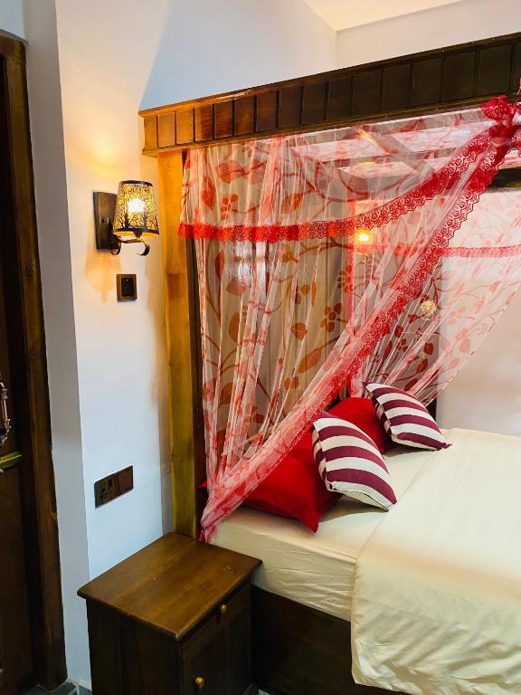 Postel nebo postele na pokoji v ubytování Madushanka Resort