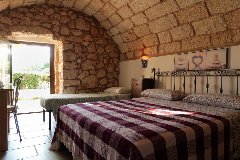 Postel nebo postele na pokoji v ubytování Palacca, trullo salentino