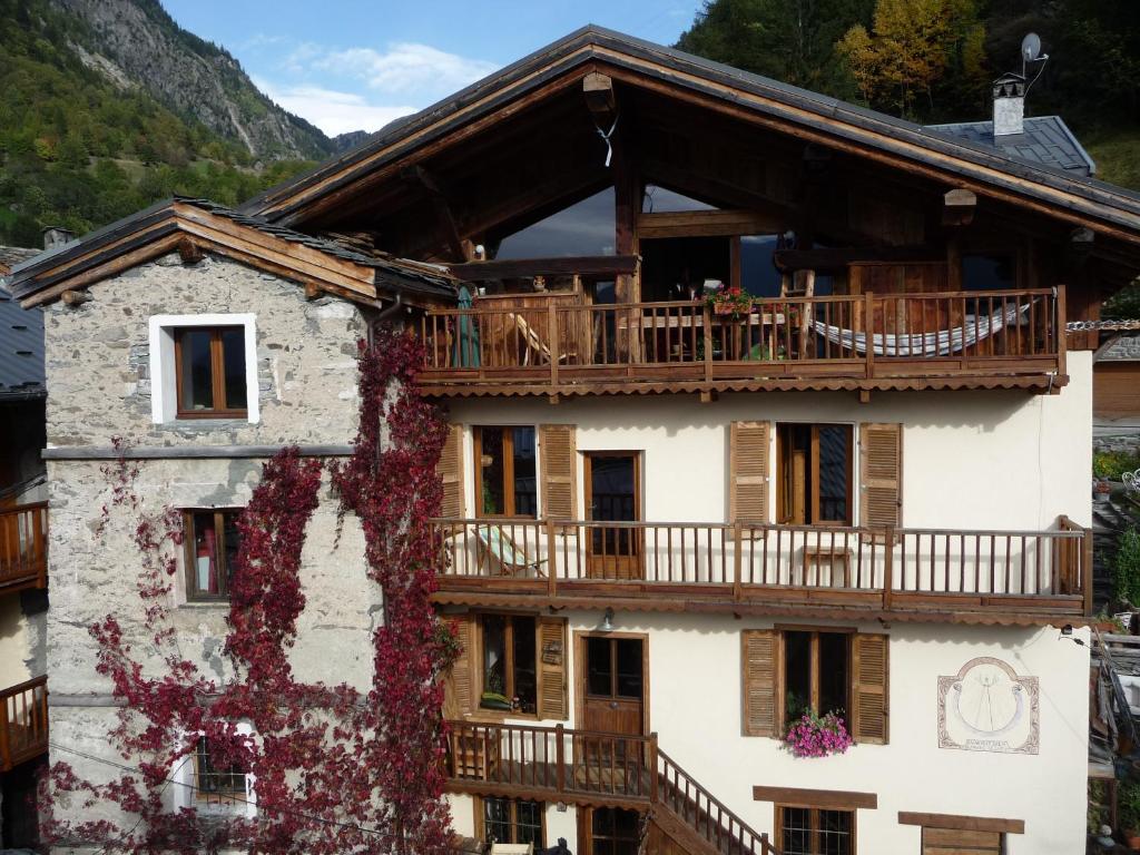 an apartment building with a balcony and a deck at Chez Michel in Sainte-Foy-Tarentaise