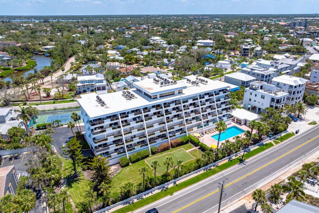 an aerial view of a large white building with a pool at Tivoli by the Sea in Siesta Key