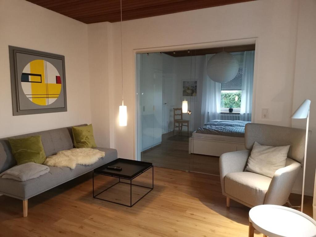 a living room with a couch and a table at Renovierte Wohnung zentral in Lemgo in Lemgo