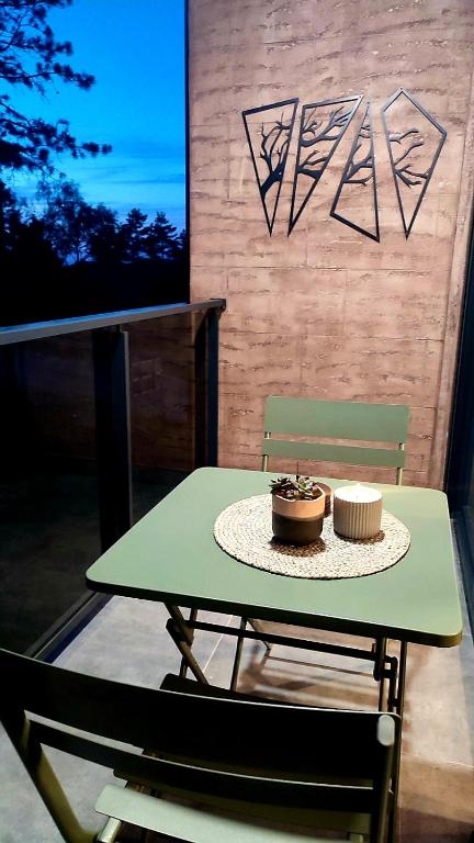 a green table with a cupcake on top of it at FOREST SIDE Apartmani in Divčibare
