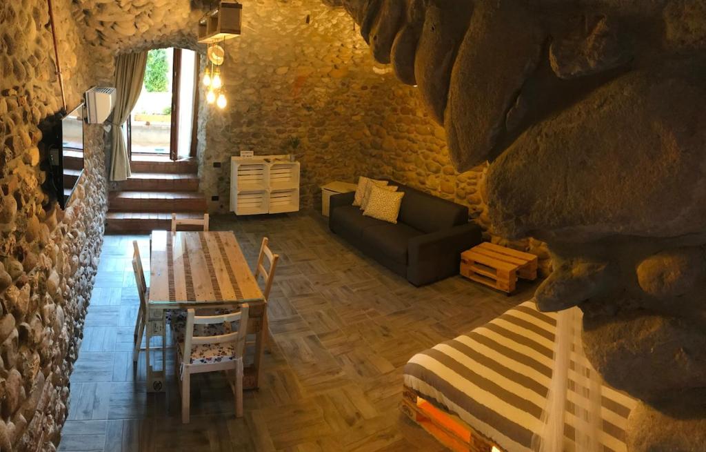 a living room with a table and a couch at La Grotta in Pastrengo