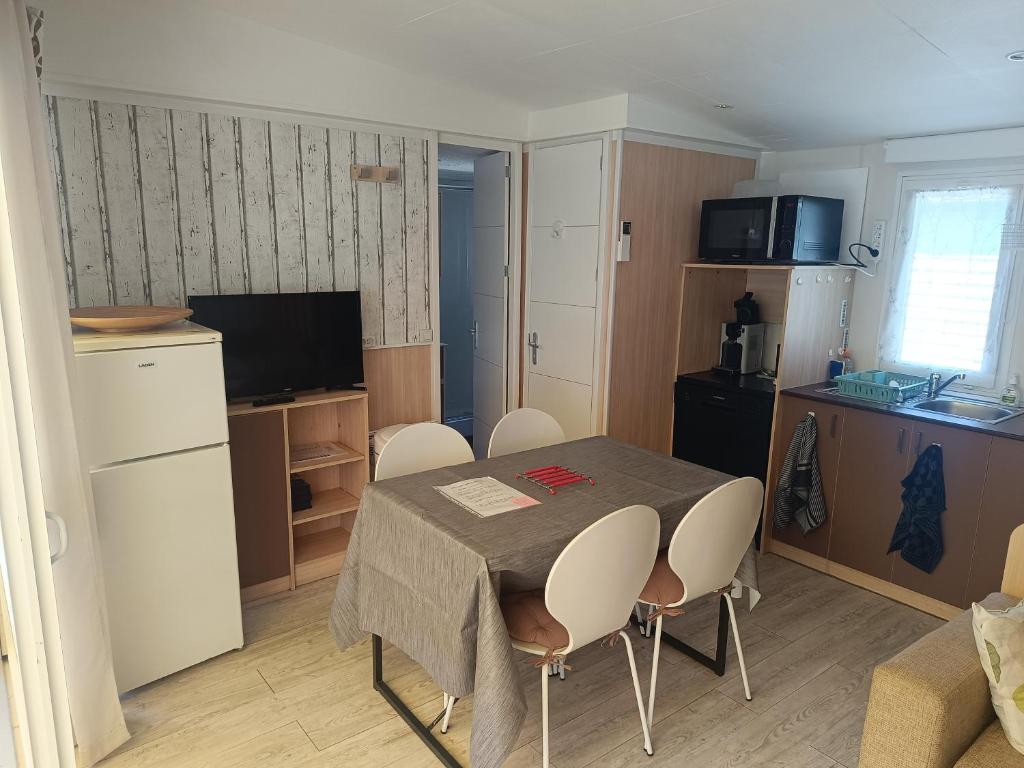 a kitchen and a table and chairs in a room at Mobile home in Fabras