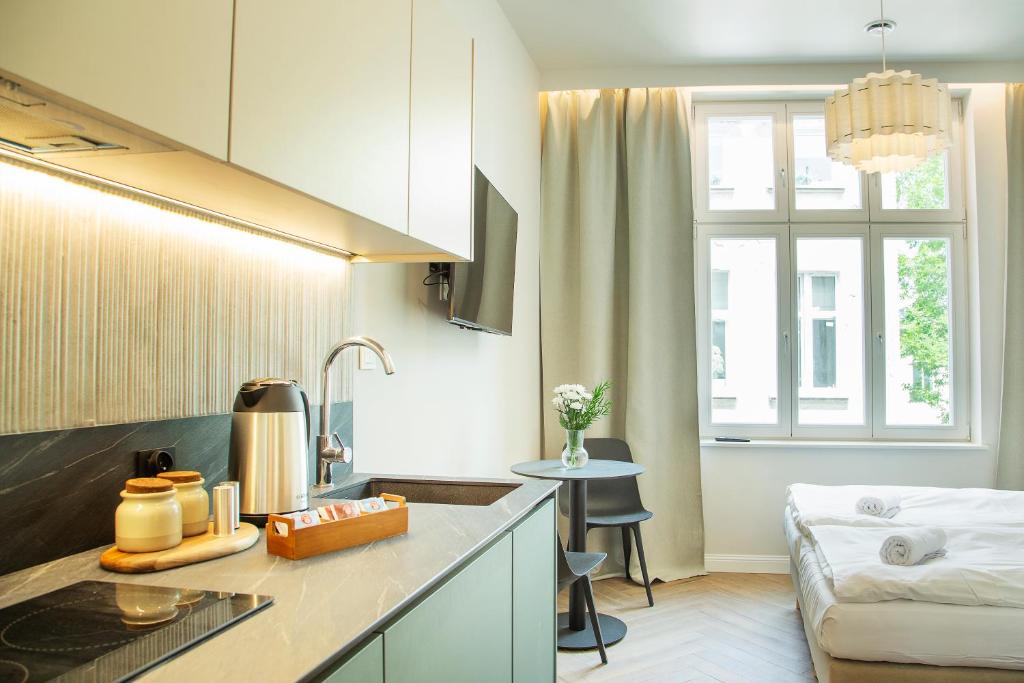 a kitchen and living room with a couch at Monte Cassino Tower in Sopot