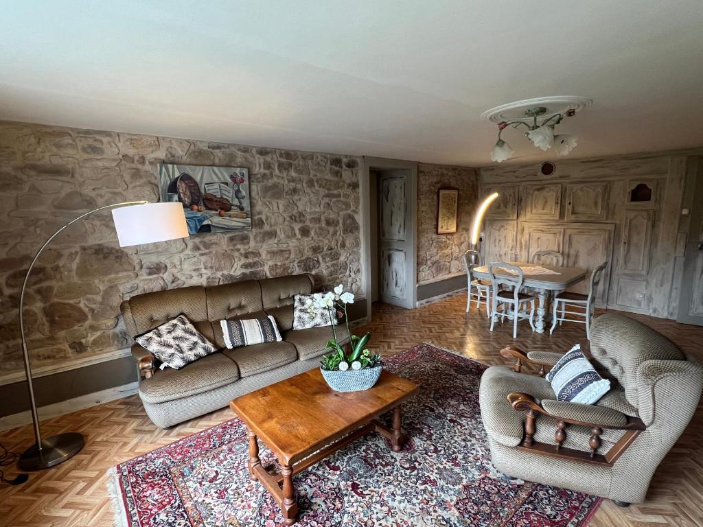 a living room with a couch and chairs and a table at Grande maison Lorraine in Vacqueville