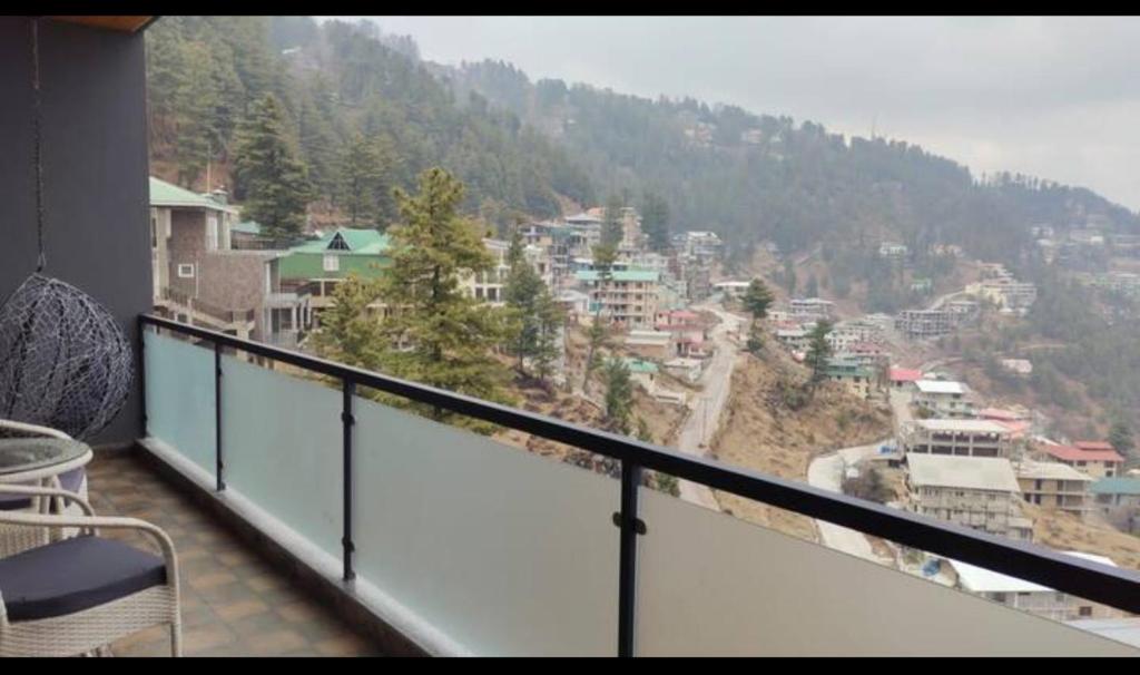a balcony with a view of a city at Maple vista in Dargai