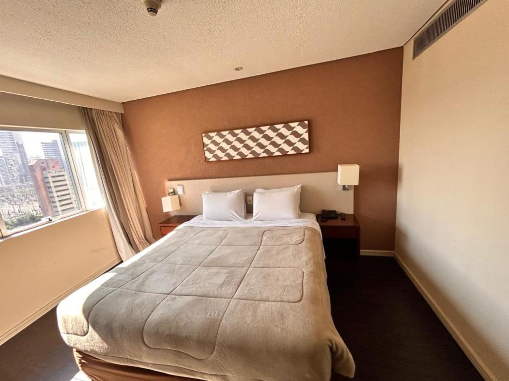 Кровать или кровати в номере Jardim Berrini