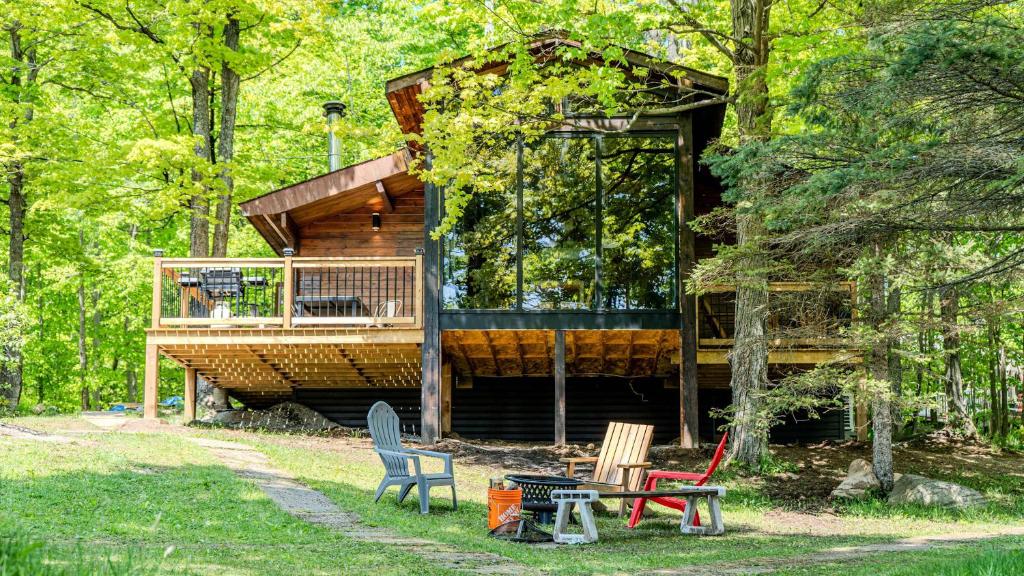 a tree house in the woods with a deck at Lake Muskoka 3-bdrm Cottage - Pier 100 #70 in Port Carling
