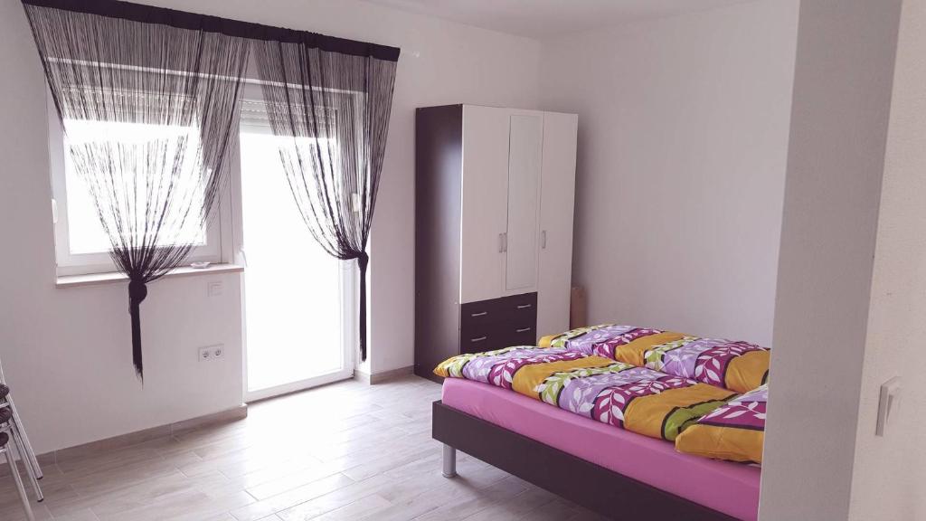 Postel nebo postele na pokoji v ubytování Apartments Magdalena