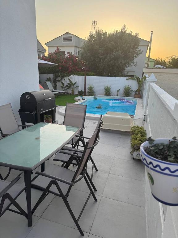 a patio with a table and chairs and a grill at Casa Estrella Gandia in Gandía