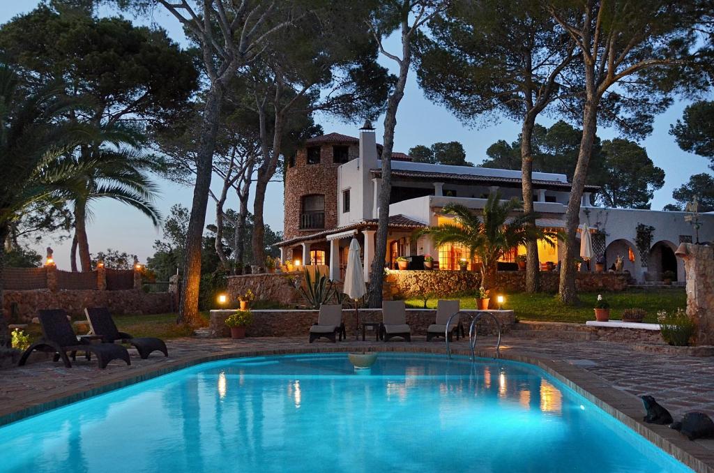 a swimming pool in front of a house at Villa Colina Ibiza in San Antonio