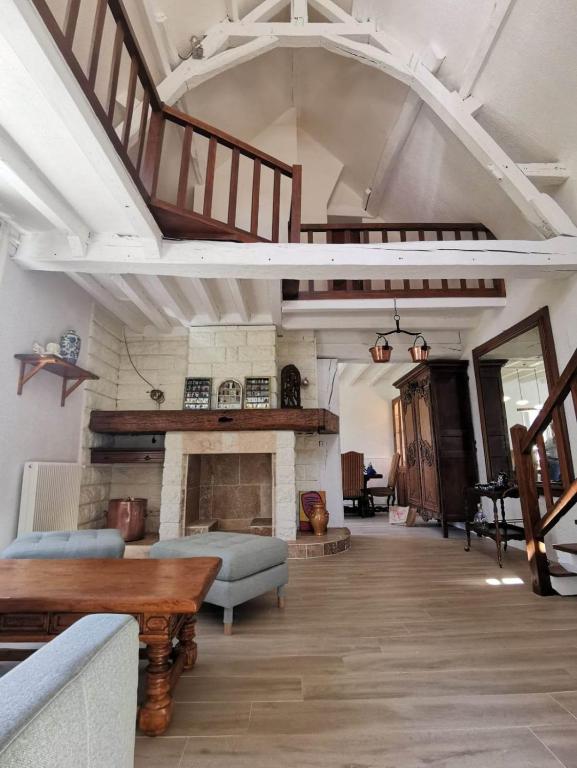 a living room with a couch and a fireplace at Chez Pierre Et Deme in Saint-Jacques-des-Guérêts