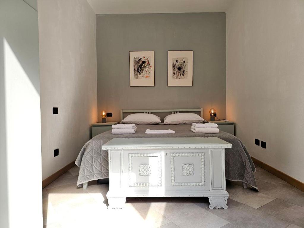 a bedroom with a bed with two pictures on the wall at Nido del Golf in Albisola Superiore