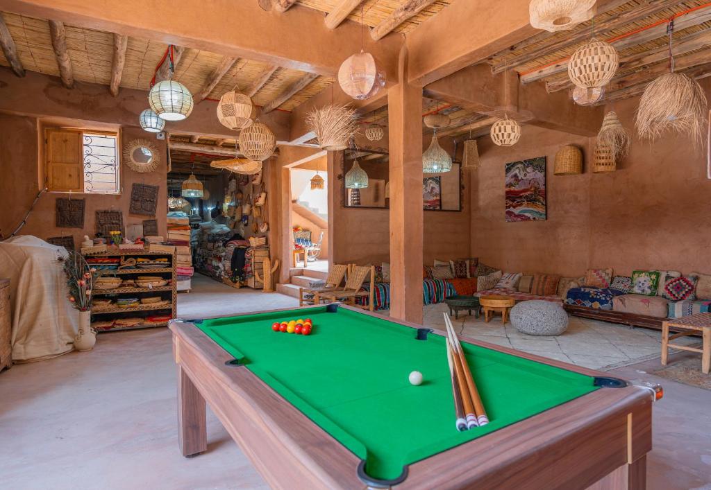 a living room with a pool table in it at Riad Azelia in Moulay Ahmed