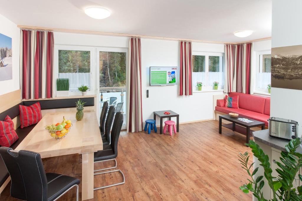 a living room with a table and a couch at Landhaus Anni in Saalbach-Hinterglemm