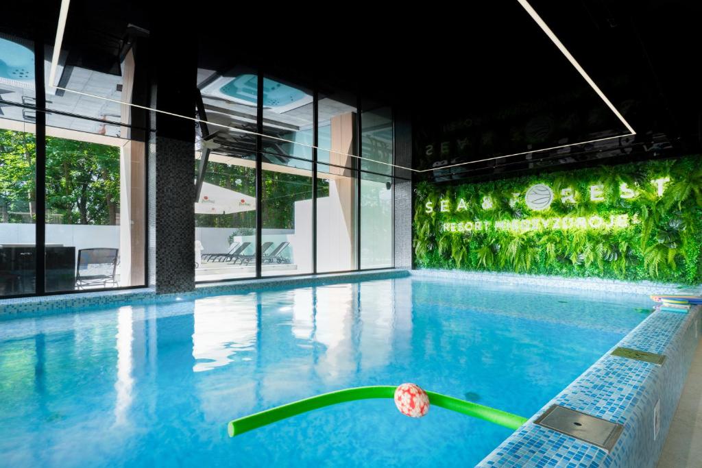 a swimming pool with a flower in front of a building at Eden Sea in Międzyzdroje