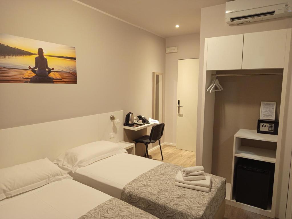 Postel nebo postele na pokoji v ubytování Hotel Acquario